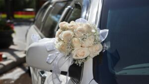 White limousine with a white flower decoration.