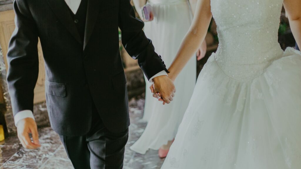Bride and Groom holding hands.