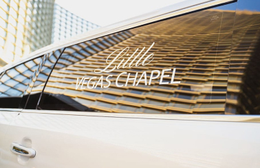 A white limousine with The Little Vegas Chapel logo on the window