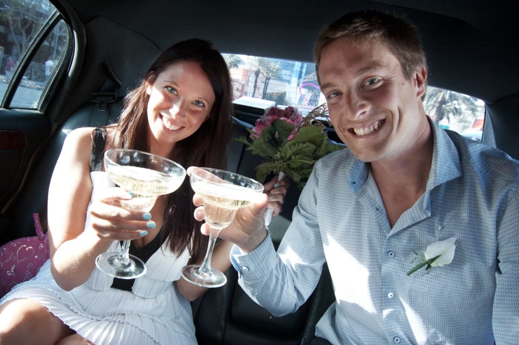 This French couple toasts in our limo after just getting married by the Little Vegas Chapel!