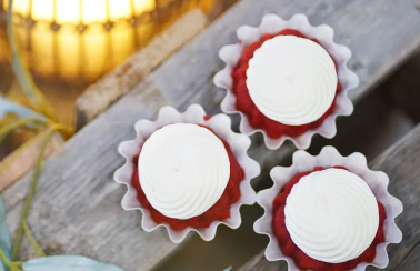 three Bundtinis red cakes with white icing on top