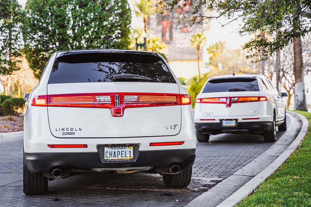 Two white Lincoln luxury cars provided by The Little Vegas Chapel, the best Las Vegas Wedding Experience!