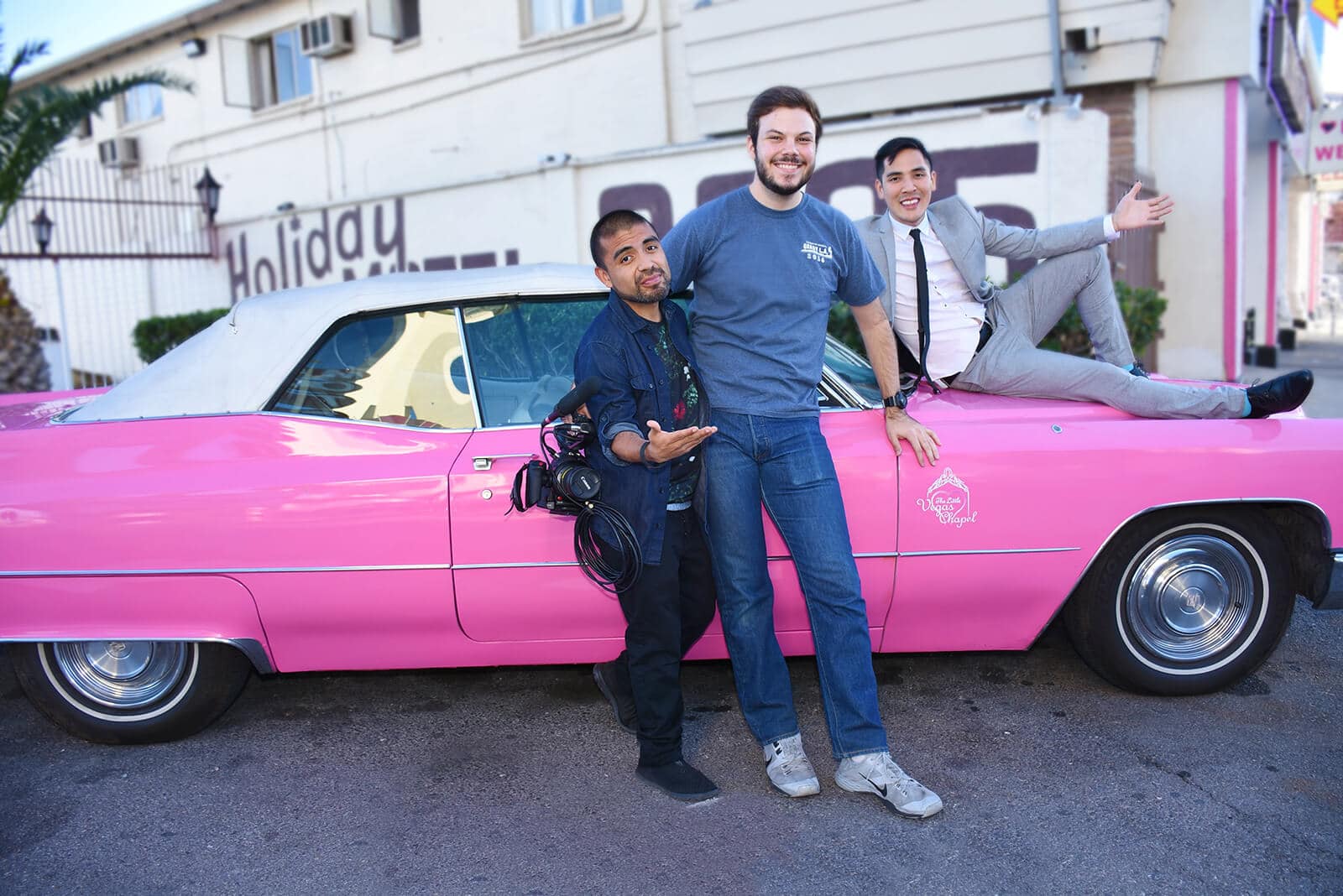 buzzfeed gets married team poses with iconic pink cadillac