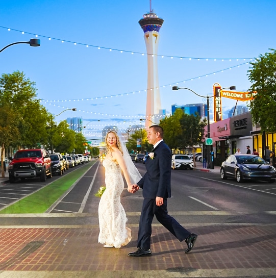 Candid image of a couple walking down the street of Las Vegas holding hands